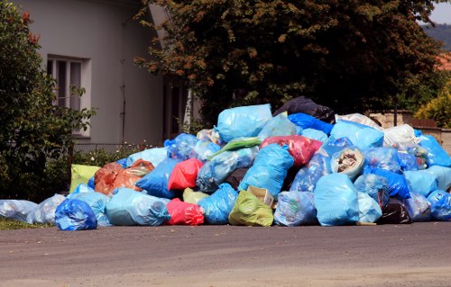 Photograph showing misplaced household waste beside a skip