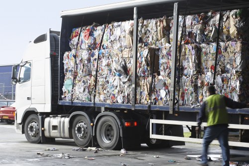 Audit inspector reviewing documents at a waste removal facility